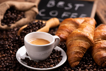  coffee cup close-up over dark roasted coffee beans