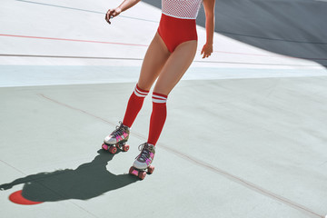 Just roll with it. Close up of girl's legs in the skatepark. She is rollerblading