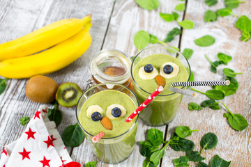 Healthy sport green smootie with honey, kiwi, spinach and milk. Children's meal