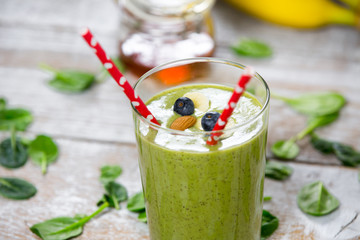 Healthy sport green smootie with honey, kiwi, spinach and milk. Children's meal