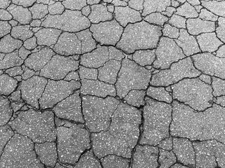 Gray street texture with many cracks and holes