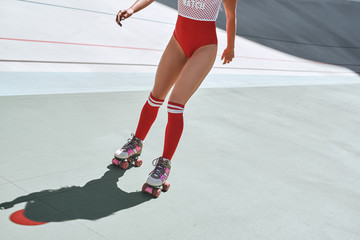 Let the good times roll. Close up of girl's legs in the skatepark. She is rollerblading