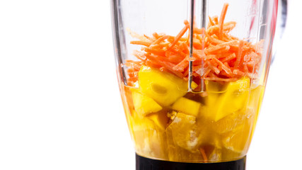 mango, orange and carrot smoothie ingredients in the blender