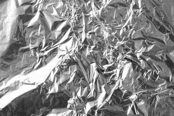 Crumpled silver aluminum foil background, abstract texture