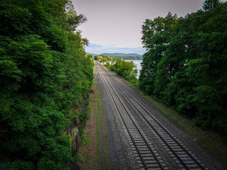 Railroad going through the forest to the hills and sky. Summer 2018. Cold Spring. USA.