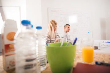 Young Architects chilling on their phones and acting not interested in the project they have.