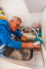 Handyman fixing the kitchen faucet