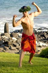 A masculine male hula dancer exhibits his manly hula style.
