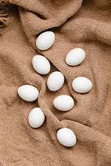 Fototapeta na wymiar White Chicken Eggs On Burlap Background, Top View