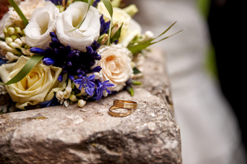 bride holding wedding bouquet with roses