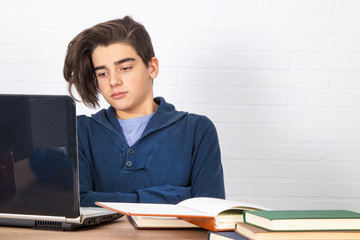 young student with computer and books on the desk