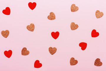 Minimal Valentine's day background. Heart shaped confetti on pink pastel background. Holiday decoration concept.