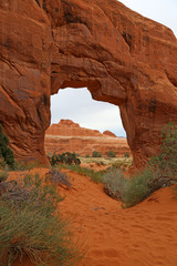 An overcast shot of the Pine Tree Arch in the Devils Garden in Arches National Park, Utah.