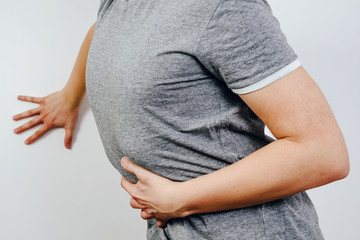 Abdominal pain, stomach problems. Medical and health concept. The man suffers from stomach pain,...