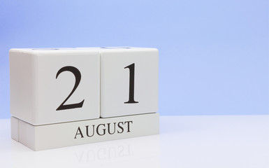 August 21st. Day 21 of month, daily calendar on white table with reflection, with light blue background. Summer time, empty space for text