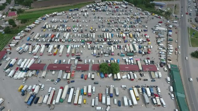 Aerial shot of farmer`s market with semi-trailer and double trucks in Ukraine 