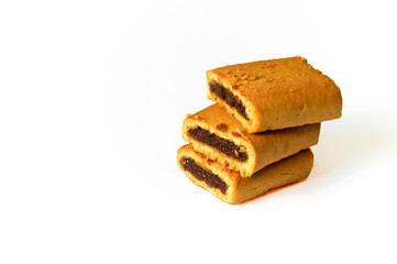 stack of three fig bar cookies on white background, not isolated, with copyspace.