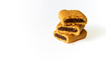 stack of three fig bar cookies on white surface, not isolated, with copy space