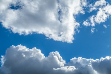 fluffy white clouds in a sun shower