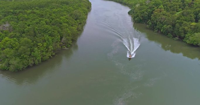 Aerial footage The boat moves through the mangroves on the river