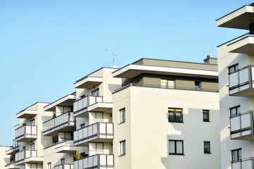 Modern white building with balcony on a blue sky