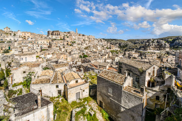 Fototapeta na wymiar The ancient sassi di Matera caves, the Rock Church and medieval Sasso Barisano and village in the city of Matera, Italy, in the Basilicata region of Southern Italy, an Unesco World Heritage Site.