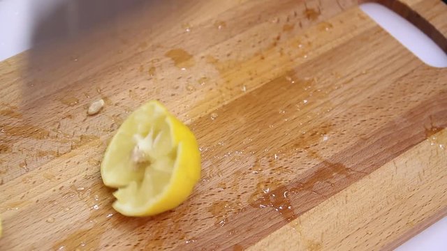 Knife a cutting juicy lemon on a white background.