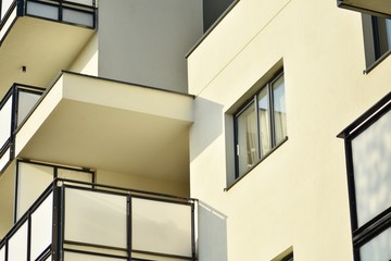 Modern white building with balcony on a blue sky