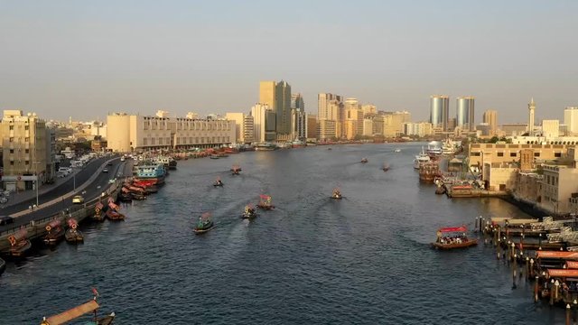 Aerial hyperlapse of navigable river crossing suburbs, Dubai, U.A.E.