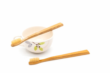 Bamboo toothbrush on ceramic mug.