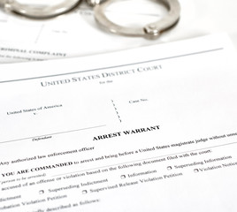 Arrest Warrant Court papers with Handcuffs