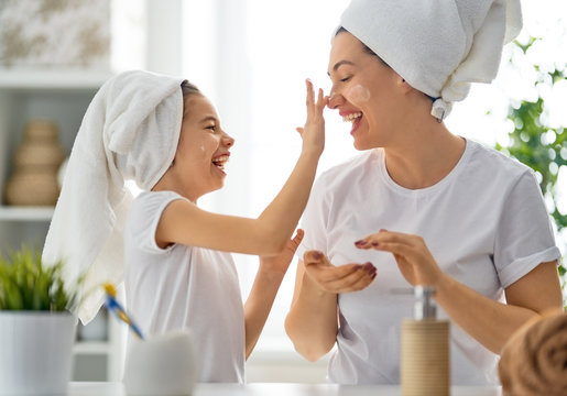 Mother and daughter caring for skin