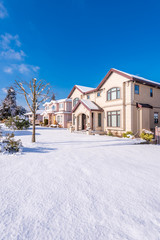A perfect neighbourhood. Houses in suburb at Winter in the north America. Luxury houses covered nice snow.