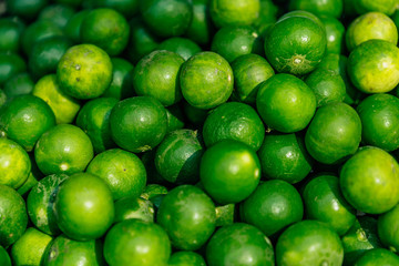 Ingredients Top View, Fresh lime Citrus, green limes background, Manaw is Thai call, top view at Fresh market in Thailand 