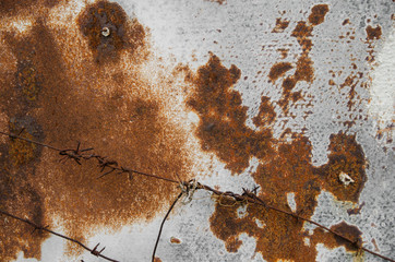 rusty barbed wire against rusty metal fence. grunge abstraction - image