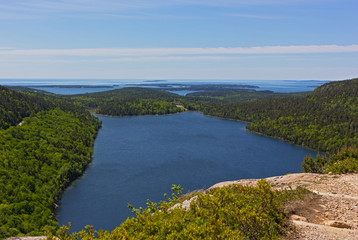 A lake in Acadia National Park, Maine, USA. Scenic panorama with horizon over the ocean waters.