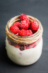 Healthy refreshment breakfast with yogurt, frozen raspberry and chia seeds. Selective focus. Shallow depth of field.