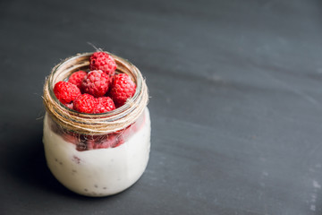 Healthy refreshment breakfast with yogurt, frozen raspberry and chia seeds. Selective focus. Shallow depth of field.