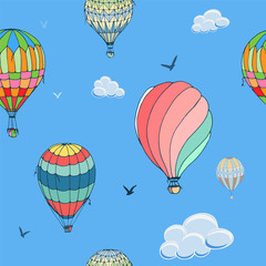 Obraz premium Balloons seamless vector pattern on blue background. Many differently colored striped air balloons flying in the clouded sky. Clouds and birds soaring in the sky. Travel and vacation. Wide horizons. 