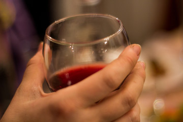 hand hold wine glass, red alcohol, clean glass