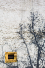 Yellow Ventilation Window and Shadow of Tree at Chateau de Neuchatel - Neuchatel, Switzerland