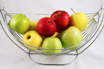 Ripe apples in metallic modern vase isolated on white 