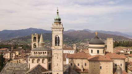 Fototapeta na wymiar Bergamo, Italy. Drone aerial view of the old town. Landscape at the city center, its historical buildings, churches and towers