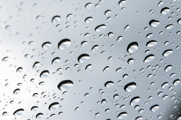 close up shot on droplets of the rain on window glass.