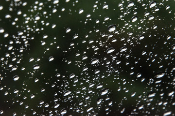 close up shot on droplets of the rain on window glass.