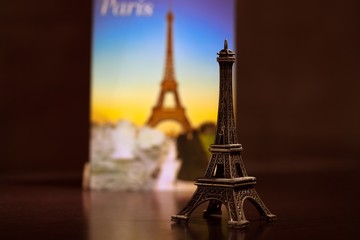 postcard from Paris and a souvenir are on the table