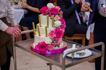 wedding cake takes the waiter in a restaurant