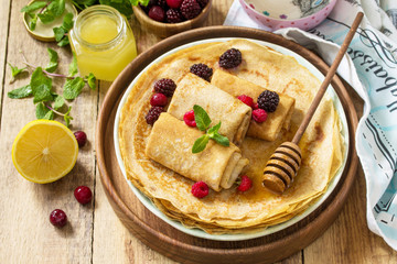 Healthy Pancakes breakfast. Stack of homemade thin pancakes or crepes on a rustic table, served...