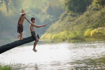 Children poverty living in countryside Vietnam are fishing at the river,Rural concept of Asia