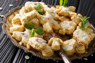 Homemade tasty cookies with pecans, anise, zest and mint close-up on a dish. horizontal